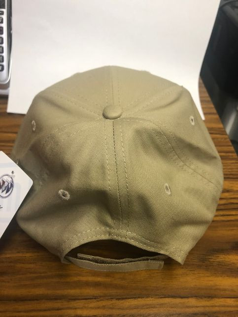 Beige baseball cap on wooden table